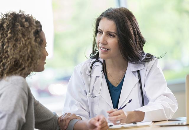 doctor speaks to patient in office